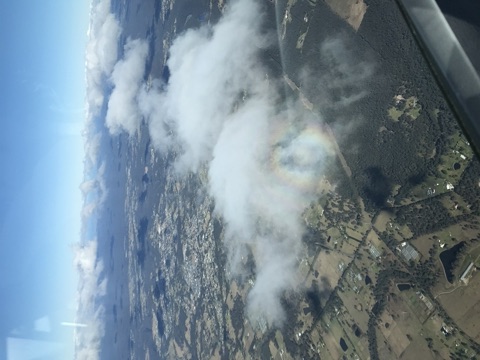 Rainbow visible through clouds while soaring